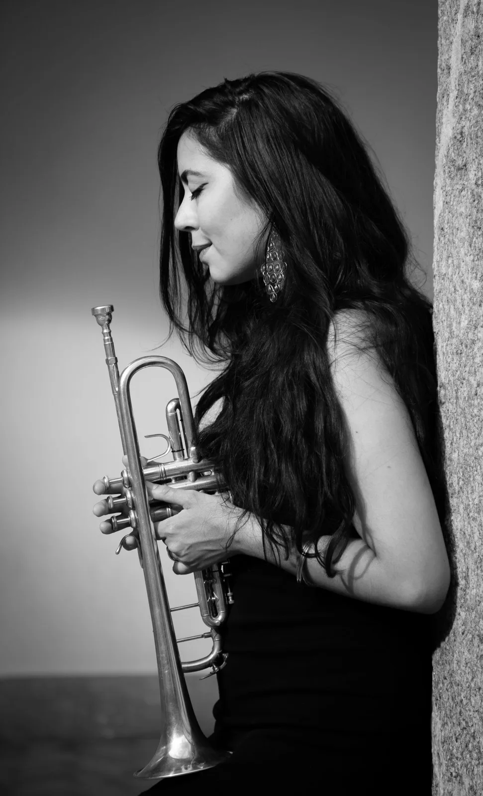 Maria Valencia performing on stage with trumpet